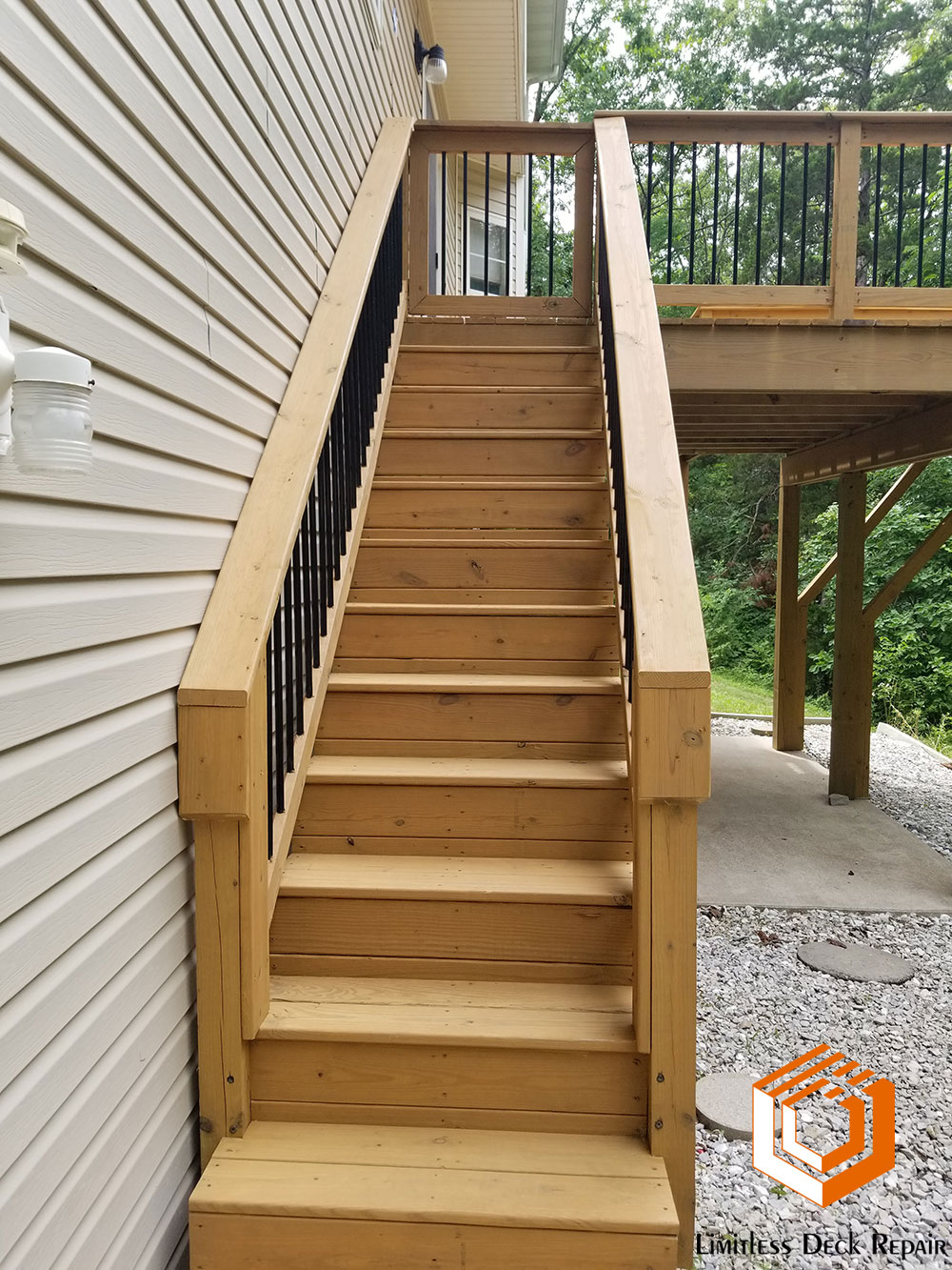 Two Level Wooden Deck Repair and Restaining with Replacement Metal Spindles on Decks Stairs by Limitless Deck Repair in Columbia Missouri After